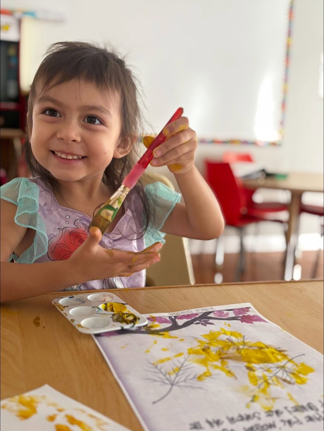 Child painting at the art table