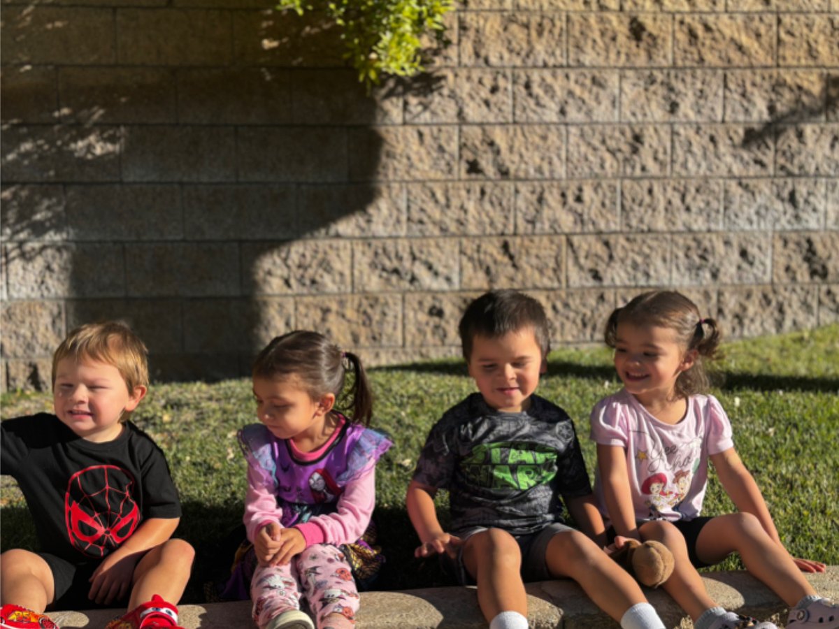 Toddlers sitting together outside
