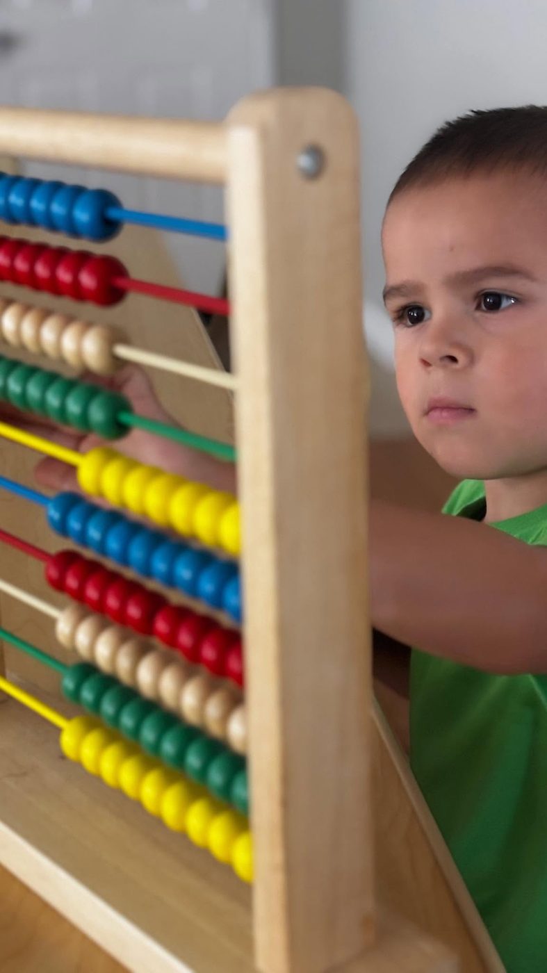 Student counting beads on a math abacus