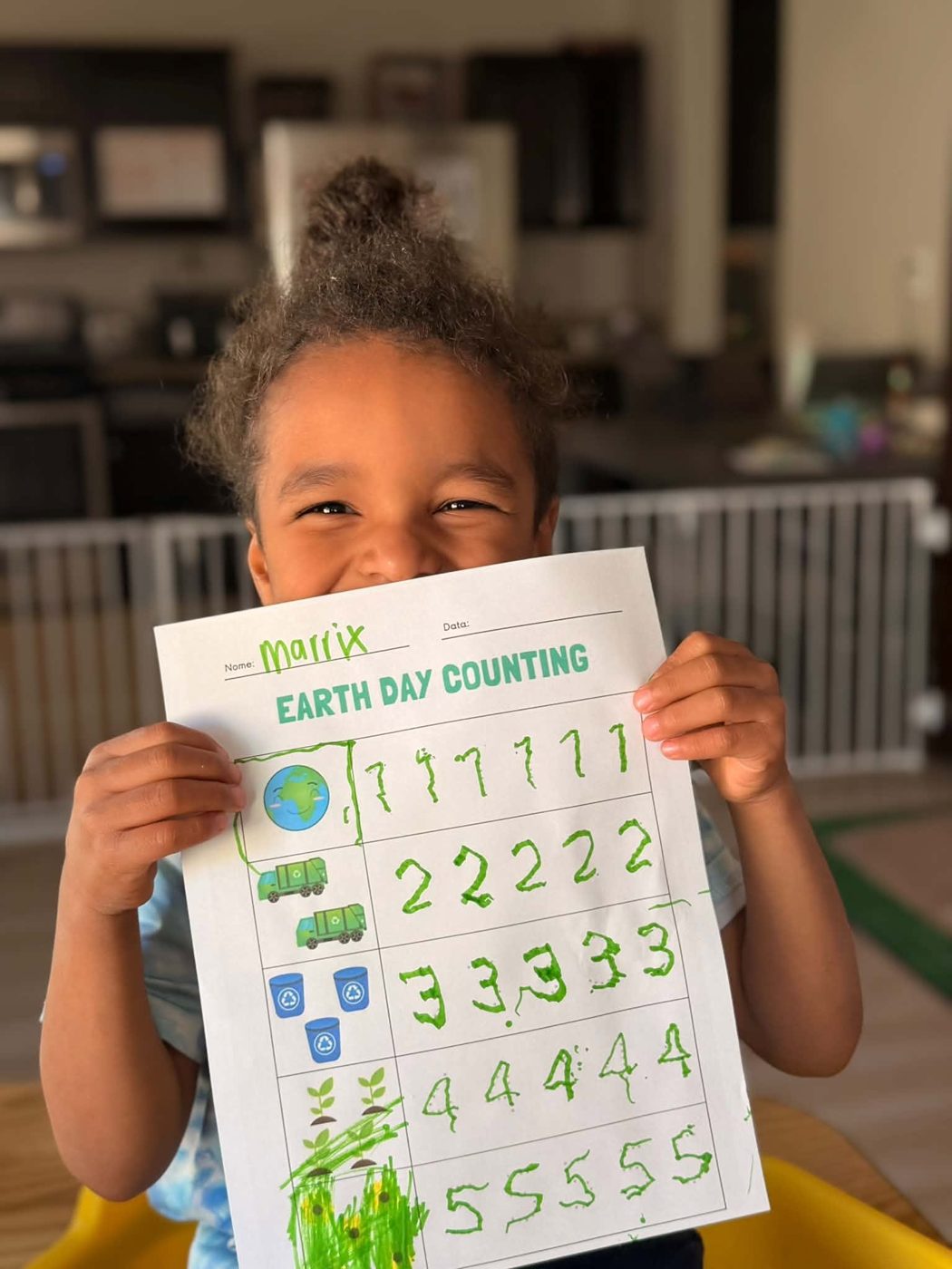 A child holding a counting worksheet